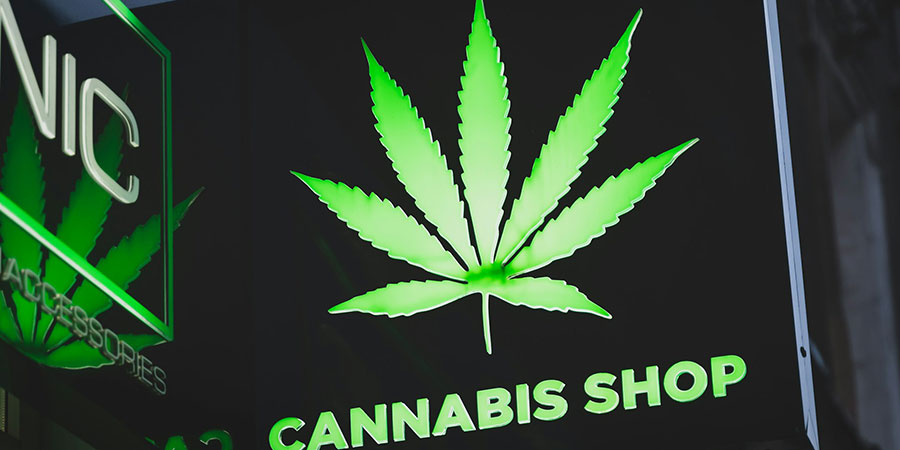 Cannabis shop signage mounted on the exterior side of the establishment